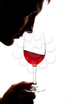 Silhouette of man degusting wine. Isolated on white