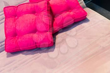 Colorful beautiful pink pillows on hotel bed