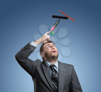 Businessman with stationery holding on his nose