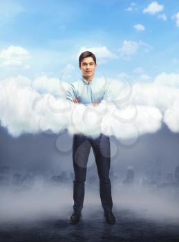 Young happy businessman above the cloud sky