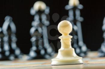 White pawn standing in front of the black team