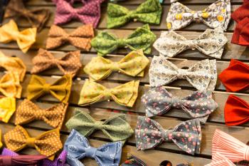 Multicolored vintage bow-ties with flowers on the board