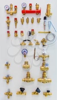 Different taps and other plumbing equipment on the wall