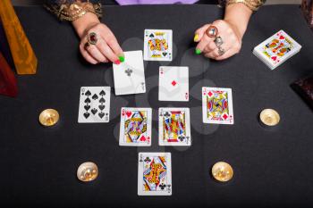 Sorceress telling fortunes using cards and candles