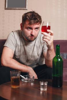 Adult grunge man with glass of alcohol. Drunker in hard drinking.