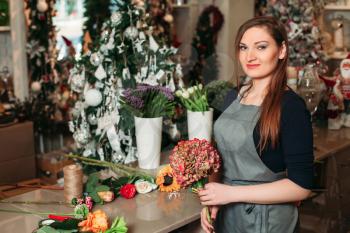 Woman holding beautiful bouquet of flowers. Florist with her work.