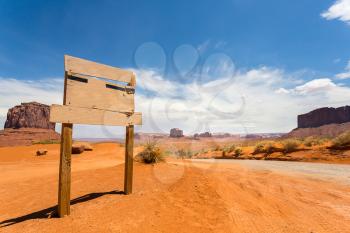 Empty sign on monument valley road with rocky mountains on background