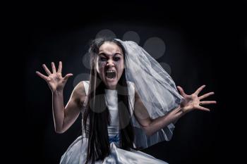 Screaming upset bride. Disheveled woman with tear-stained face in wedding dress and white veil