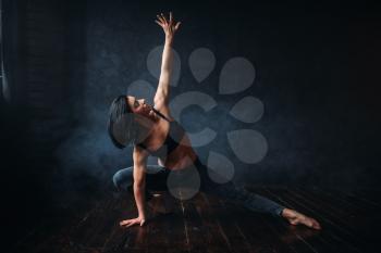 Contemp dancing female performer exercise in dance class. Woman pose in studio, acrobat body flexibility