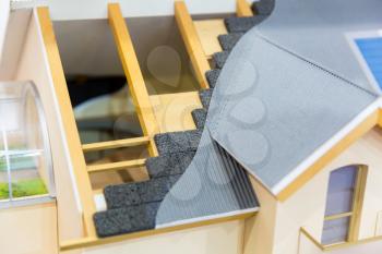 Model of house, thermal insulation of roof concept. Energy and money saving materials and systems