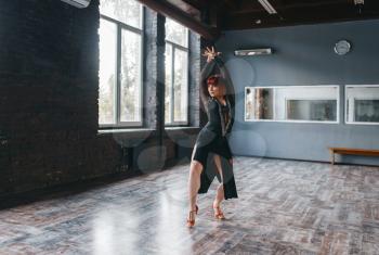 Woman on ballrom dance training in class. Female person in dress, professional pair dancing in studio