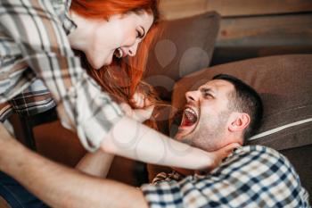Angry wife beats her husband, domestic violence, quarrel, agressive couple fight. Man and woman in conflict. Problem relationship