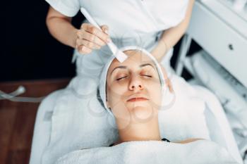 Beautician makes rejuvenation procedure to female patient, cosmetology clinic. Facial skincare in spa salon, health care
