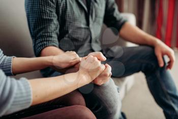 Couple hold hands at psychologist, family psychology support, civilized solution to the problem. Female doctor helps patients with consultation