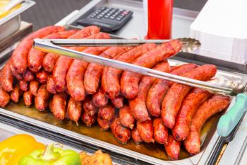 Tasty fried sausages on a tray in the dining room. Hotel cuisine, traditional european food