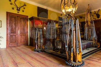 Room with old weapons, ancient armory storage, Europe. Medieval european guns
