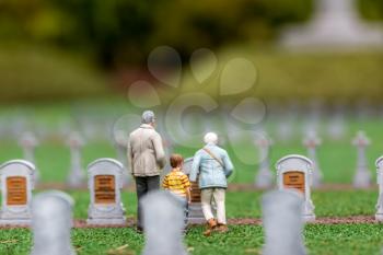 People visit the cemetery, grave stones and green grass, miniature scene outdoor, europe. Mini figures with high detaling of objects, realistically diorama, toy model