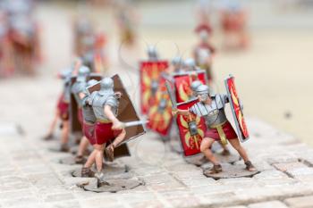 Roman soldiers battle, war miniature scene outdoor, europe. Mini figures with high detaling of objects, realistically diorama, toy model