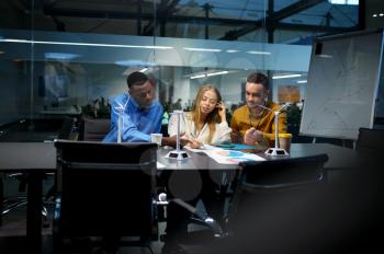 Team of managers at the table, IT idea presentation in office. Professional teamwork and planning, group brainstorming and corporate work