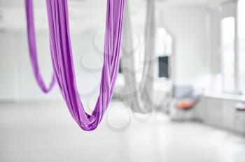 Aerial yoga, hammock, studio interior on background, nobody. Fitness, pilates and dance exercises mix. Fly yogi concept, workouts in sports gym