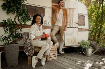 Love couple relaxing in rv, adventure on wheels, camping in a trailer. Man and woman travels on van, romantic vacations on motorhome, campers leisures in camping-car