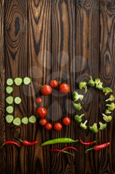 Vegetable ECO word isolated on wooden background, top view. Organic vegetarian food, grocery assortment, natural eco products, healthy lifestyle concept