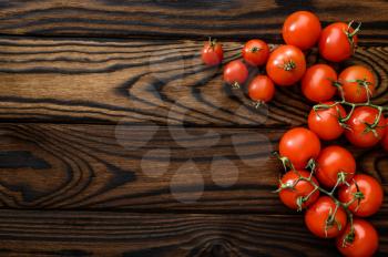 Fresh tomatoes isolated on wooden background, top view. Organic vegetarian food, grocery assortment, natural eco products, healthy lifestyle concept
