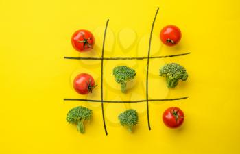 Vegetable cross-zero game isolated on yellow background. Organic vegetarian food, grocery assortment, natural eco products, healthy lifestyle concept