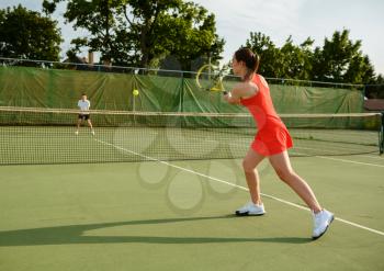 Tennis players with rackets, training on outdoor court. Active healthy lifestyle, people play sport game, fitness workout