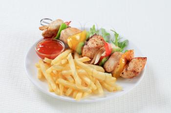 Chicken Shish kebab with French fries and ketchup