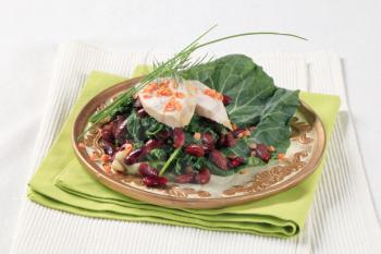 Healthy dish of legume, salad greens and slices of chicken breast