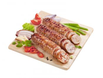 Roast pork and turkey rolls on a cutting board