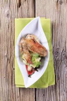 Roast chicken wing with crushed potatoes
