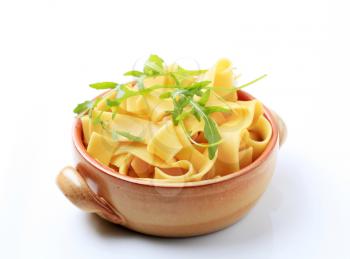 Cooked ribbon pasta in a ceramic pot