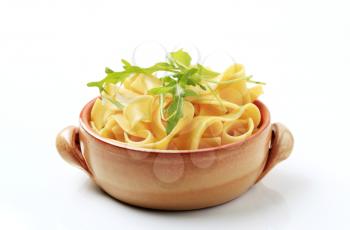 Cooked ribbon pasta in a ceramic pot
