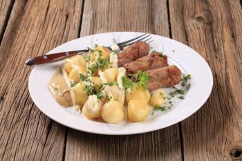 Cevapcici and potatoes with mayonnaise and mustard