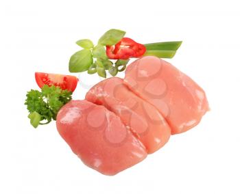 Raw chicken breast fillets and fresh vegetables