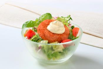 Fried cheese with fresh vegetable salad and mayonnaise