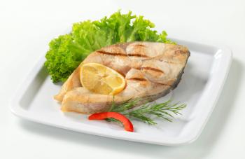 Grilled fish steak with lemon