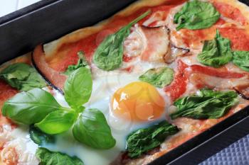 Bacon and egg pizza baked in a rectangular tray