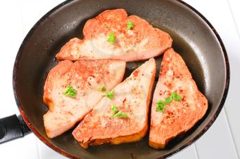 Pan fried lunchmeat on a frying pan