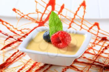 Small dish of vanilla custard topped with fruit