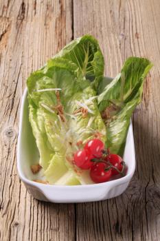 Fresh Romaine lettuce leaves and tomatoes - closeup