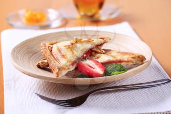 Toasted sandwich filled with strawberry jam