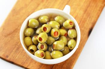 Cup of green olives stuffed with pimento