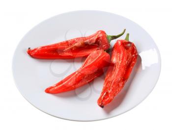 Three roasted red peppers on a plate 