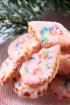 Pink frosted sugar cookies with colorful sprinkles