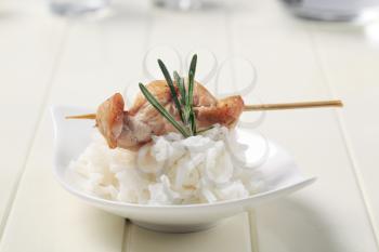 Chicken skewer on bed of white rice