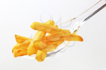 French fries on a plastic spoon - closeup