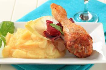 Roasted chicken drumstick served with mashed potato